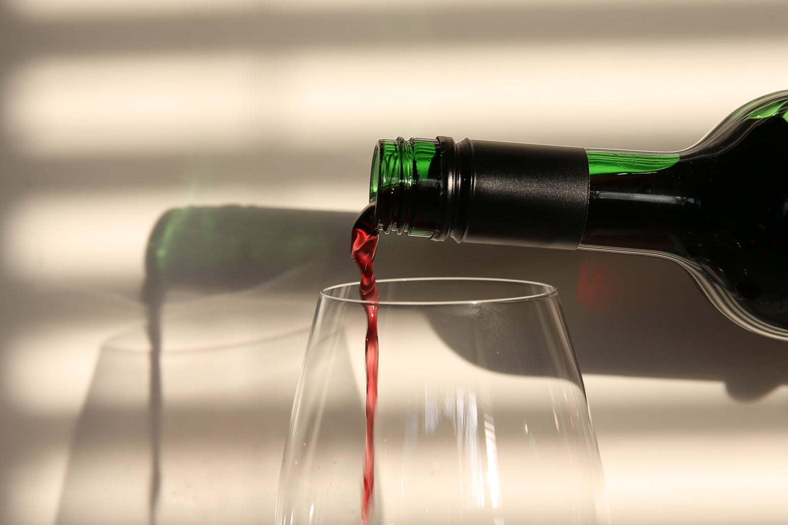 non-alcoholic red wine being poured into a wine glass