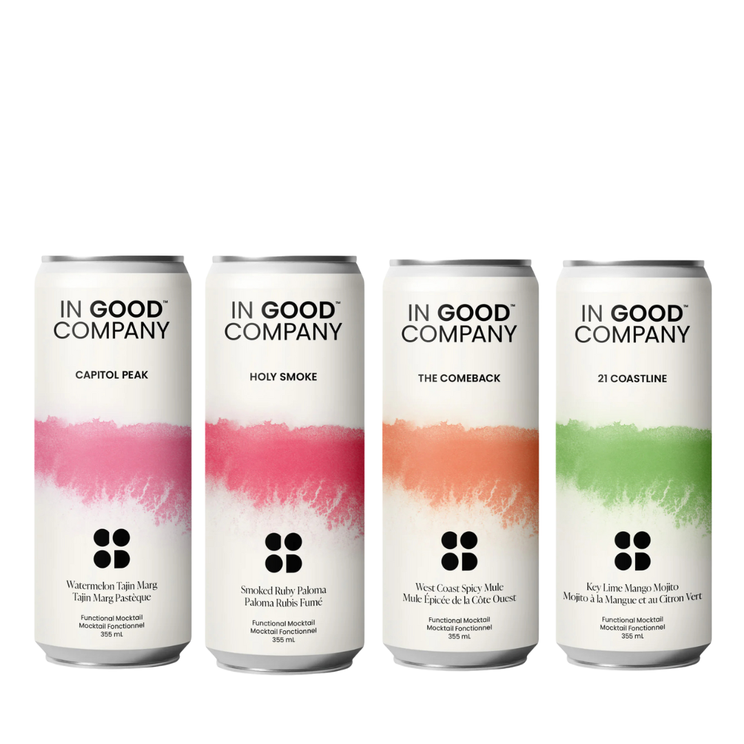 Four cans of 'In Good Company' with colorful labels on a white background