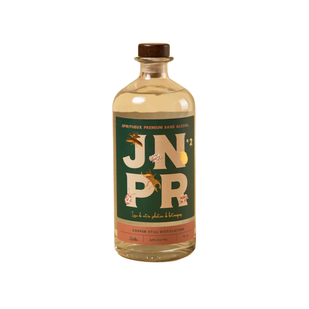 A bottle of BTR Non-Alcoholic Gin from The JNPR Bartender Series, featuring a rich amber liquid and a stylish label with bold "JNPR" typography. The design incorporates artistic illustrations of botanicals, emphasizing its premium, handcrafted essence.