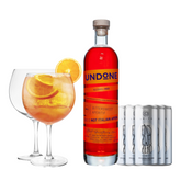 A non-alcoholic spritz cocktail bundle featuring a bottle of Undone No. 5 Bittersweet Aperitif, a set of Leitz Eins Zwei Zero Sparkling Riesling cans, and two large balloon glasses—one filled with an orange-hued spritz garnished with fresh orange slices. The aperitif bottle has a bold red-orange label with the text 'THIS IS NOT ITALIAN APERO' in uppercase letters