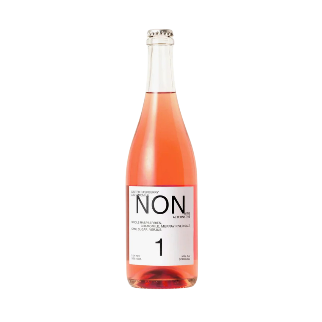 A bottle of NON 1, a non-alcoholic sparkling beverage. The bottle features a sleek and minimalist design with a white label and modern typography. The label describes its flavor profile as "Salted Raspberry & Chamomile" and lists key ingredients like whole raspberries, chamomile, Murray River salt, cane sugar, and verjus. The beverage has a blush pink hue, indicative of its fruity and