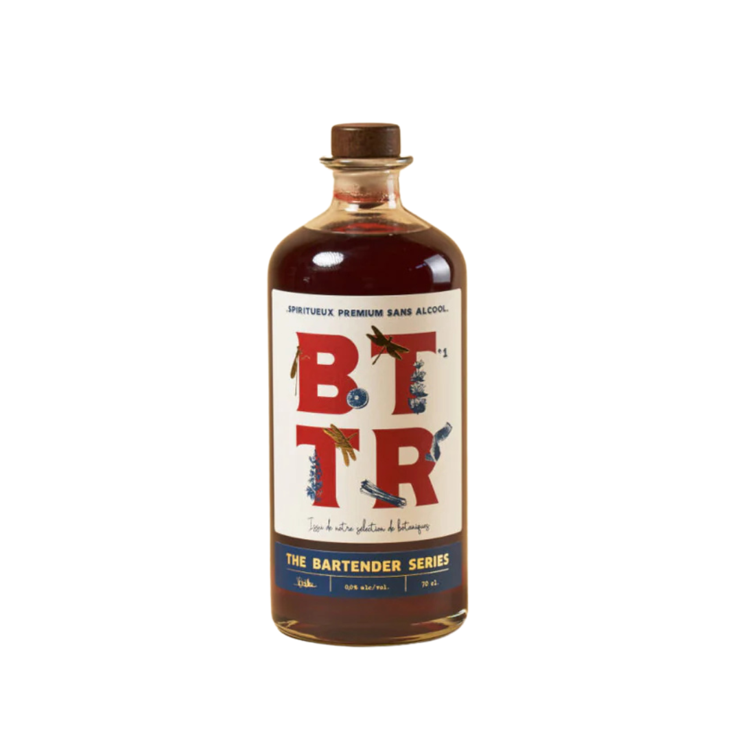 A bottle of BTR Non-Alcoholic Spirit from The Bartender Series, featuring a rich amber liquid and a stylish label with bold "BTTR" typography. The design incorporates artistic illustrations of botanicals, emphasizing its premium, handcrafted essence.