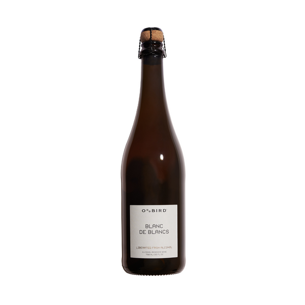 A tall, slim bottle of Oddbird Blanc de Blancs non-alcoholic sparkling wine with a white label.